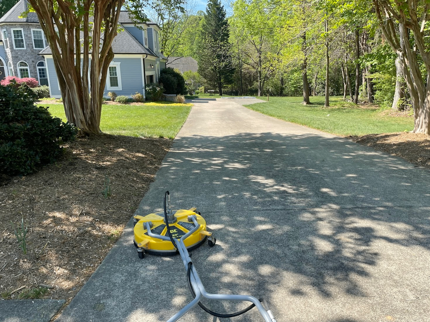 Real driveway pressure washing in Mebane NC with surface cleaner