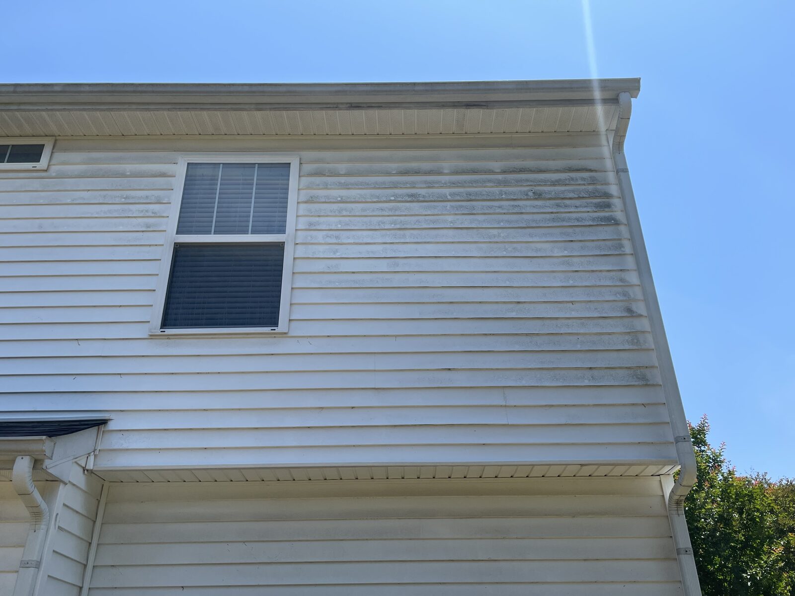 Real house siding with mildew streaks before soft wash in Mebane NC